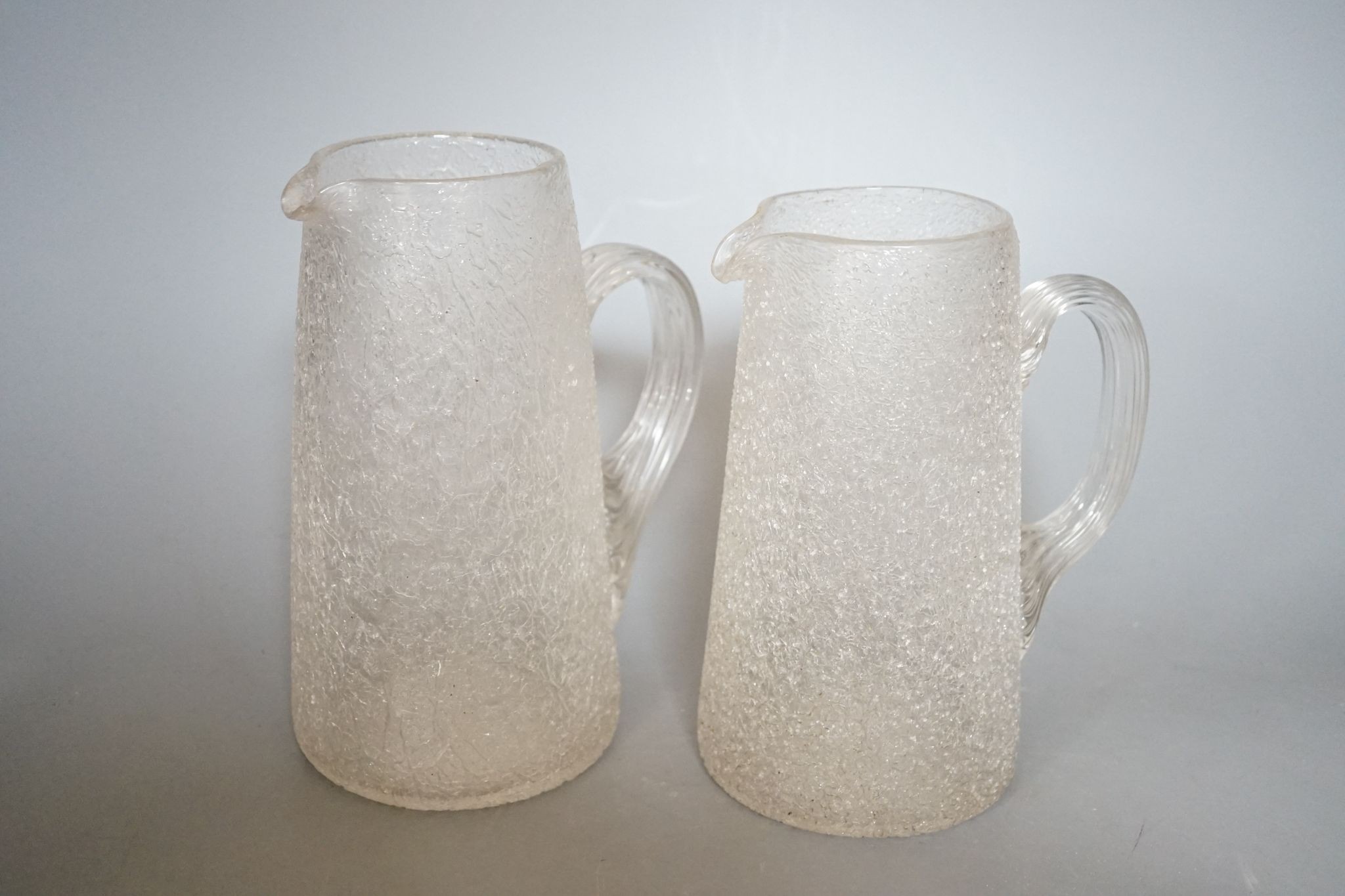 Five various Victorian iced glass jugs, 29cm